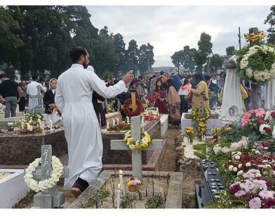 All Souls’ Day, a solemn occasion dedicated to praying for the departed, was observed with deep reverence across the Shillong Archdiocese on Sunday. The Mother Parish of Laitumkhrah, the central parish of the Archdiocese, witnessed particularly large gatherings as the faithful came together in prayer and remembrance. Hundreds of believers offered prayers, laid flowers, and lit candles at the cemetery, paying tribute to deceased family members, friends, and all the departed faithful. The faithful sought God’s mercy and eternal peace for their souls. A Holy Mass at the Grave Yard of Laitumkhrah Parish was presided over by Most Rev. Victor Lyngdoh, Archbishop of Shillong, who served as the main celebrant. In his homily, Archbishop Lyngdoh reflected on the spiritual meaning of All Souls’ Day and called upon the faithful to contemplate eternal life and the hope found in God. “Our prayer today is not only to remember those who have gone before us, but also to renew our hope in God, who grants us eternal life,” Archbishop Lyngdoh said. He urged families and communities to continue practicing acts of love, prayer, and remembrance as expressions of unity with the souls of the departed. All Souls’ Day remains an important tradition in the Catholic Church, emphasizing prayers for the souls in purgatory so that they may attain eternal rest in God’s presence. Following the Mass, Archbishop Lyngdoh led a special prayer service and blessed the graves, as the congregation joined in solemn devotion to honor and remember their loved ones who have passed on.